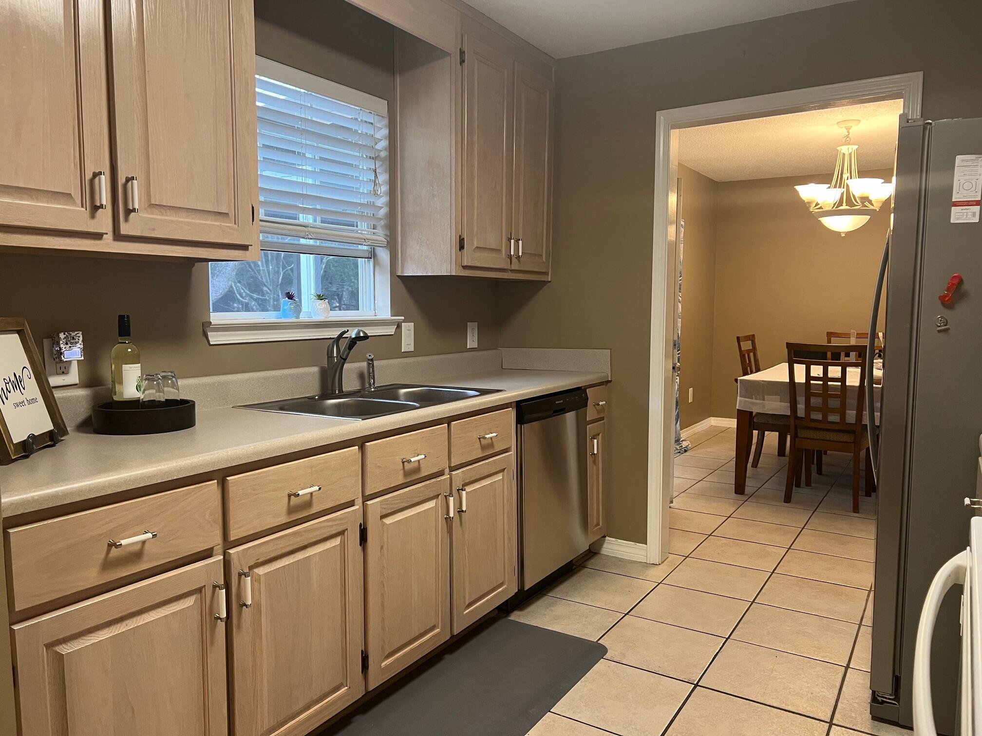 1860 Eagle Lane Navarre, FL 32566 - Photo 10 of 34 a kitchen with stainless steel appliances granite countertop a sink and cabinets