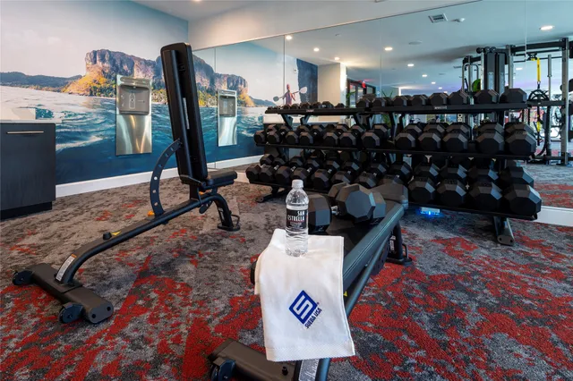 a room with lots of chairs and mirrors