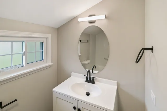 a bathroom with a sink and mirror