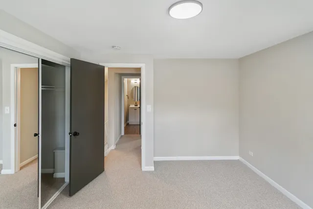 a view of an empty room with closet area