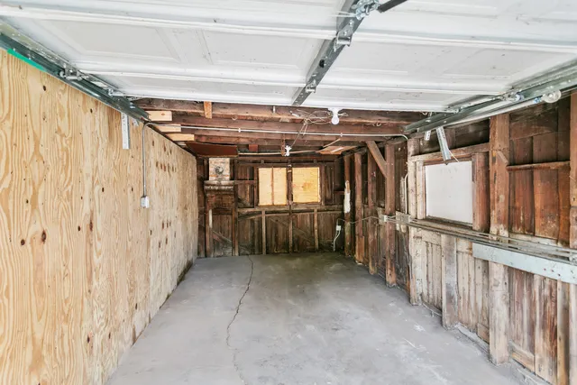 a view of an empty room with wooden walls