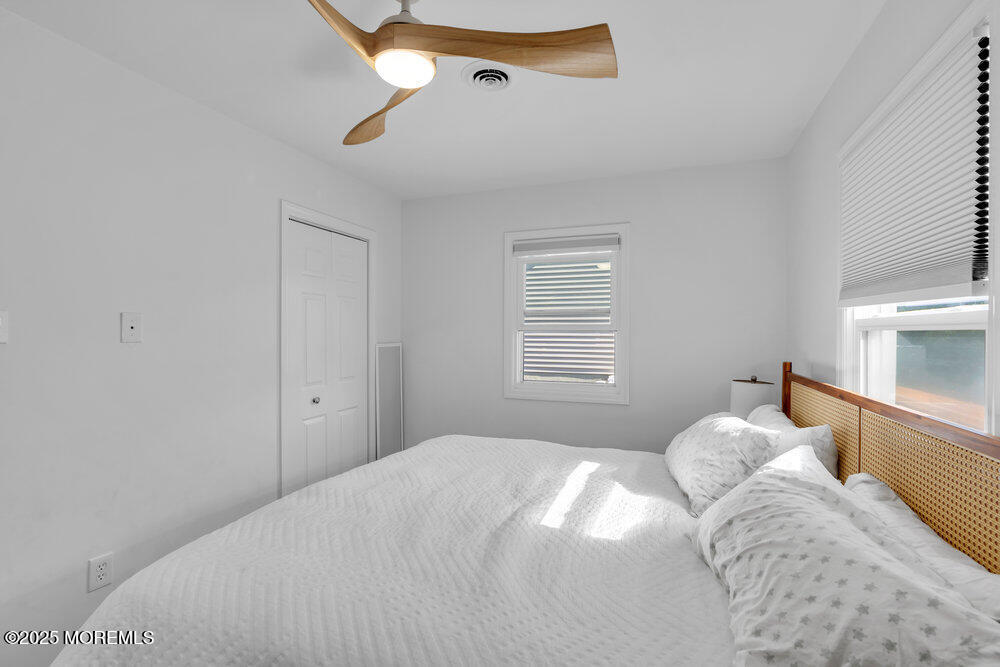 234 3rd Avenue Manasquan, NJ 08736 - Photo 17 of 25 a bedroom with a bed and a window