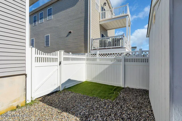 a view of a house with a small yard and wooden floor