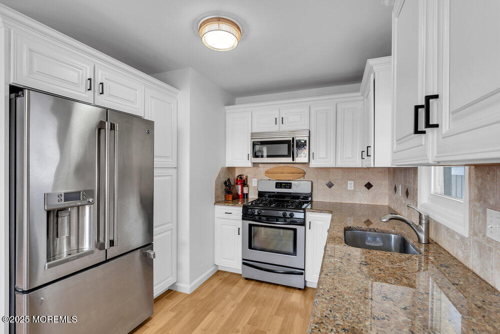 234 3rd Avenue Manasquan, NJ 08736 - Photo 9 of 25 a kitchen with stainless steel appliances granite countertop a refrigerator sink and stove