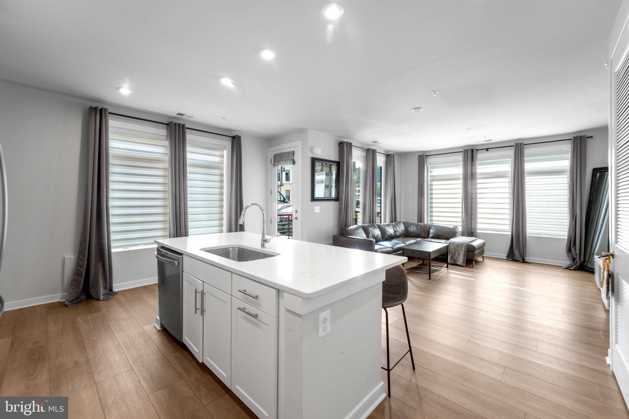1669 Bandit Loop, Unit 101A Reston, VA 20190 - Photo 14 of 35 a kitchen with sink attached with living room