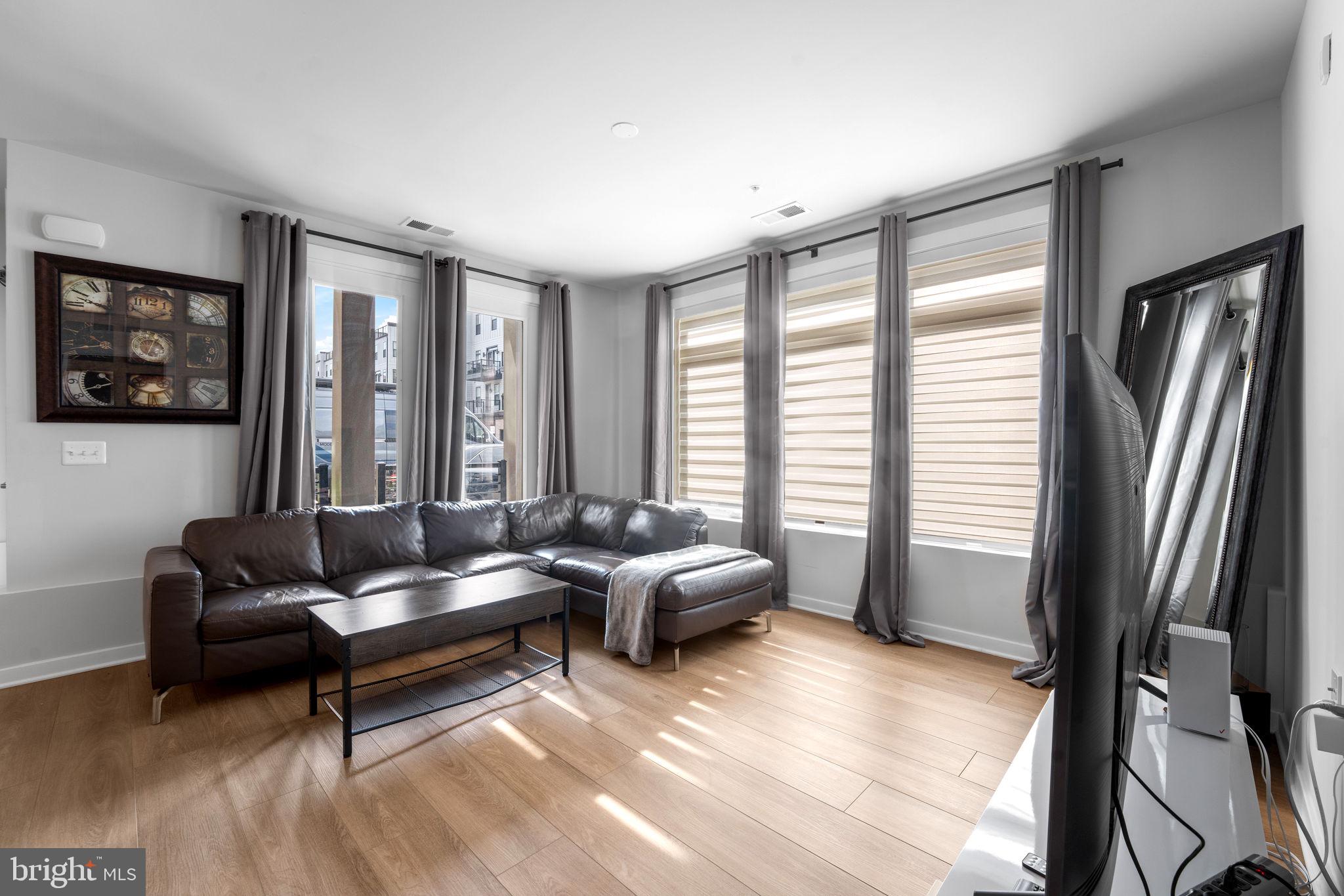 1669 Bandit Loop, Unit 101A Reston, VA 20190 - Photo 16 of 35 a living room with furniture and a large window