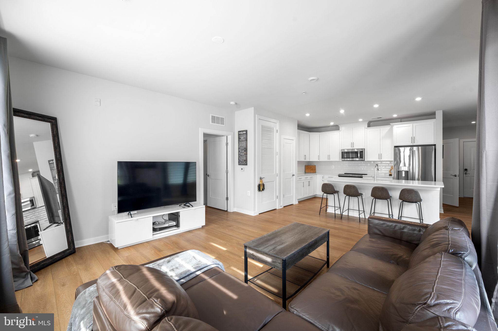 1669 Bandit Loop, Unit 101A Reston, VA 20190 - Photo 17 of 35 a living room with furniture and a flat screen tv
