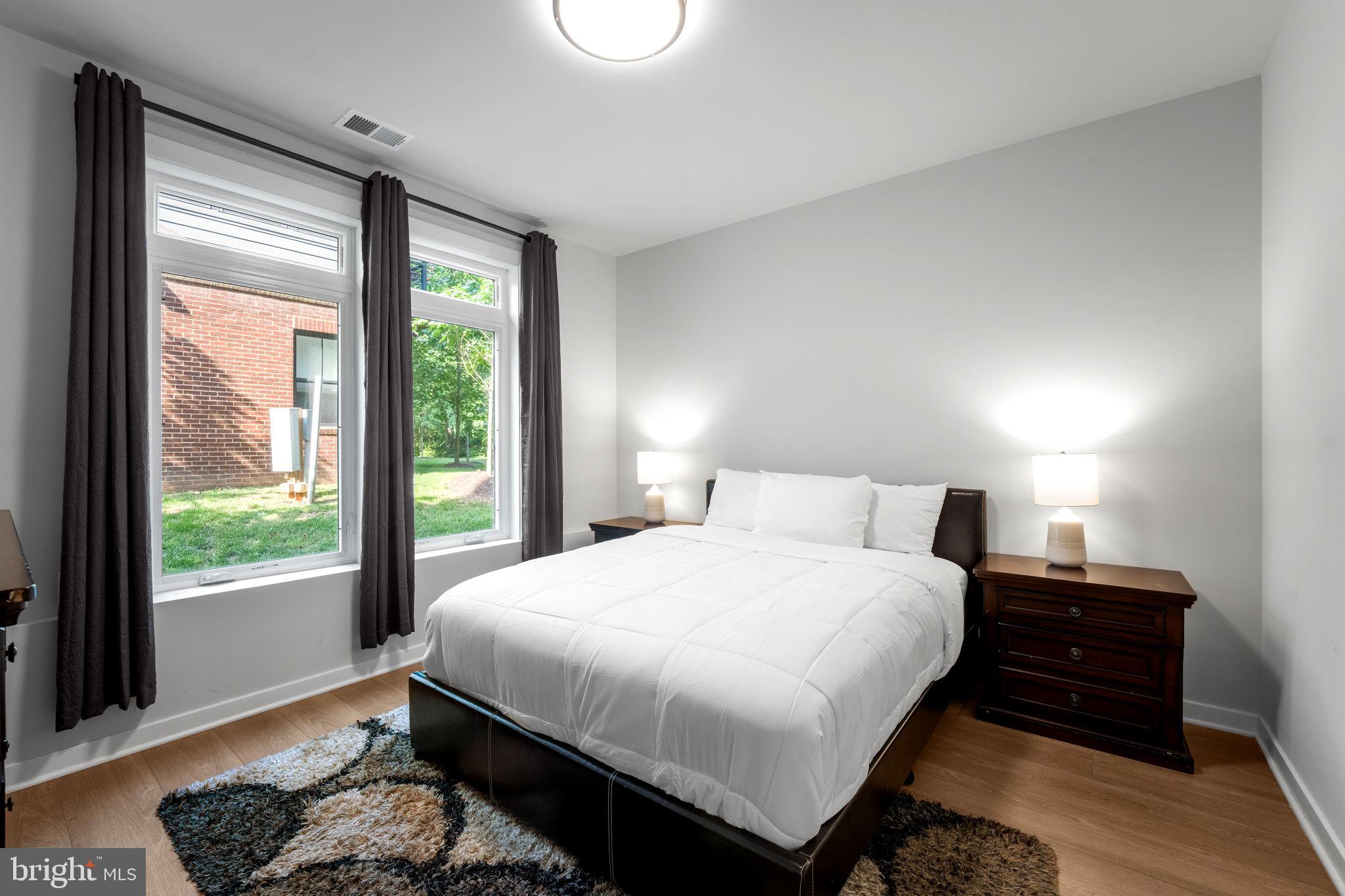 1669 Bandit Loop, Unit 101A Reston, VA 20190 - Photo 18 of 35 a bedroom with a bed and a window