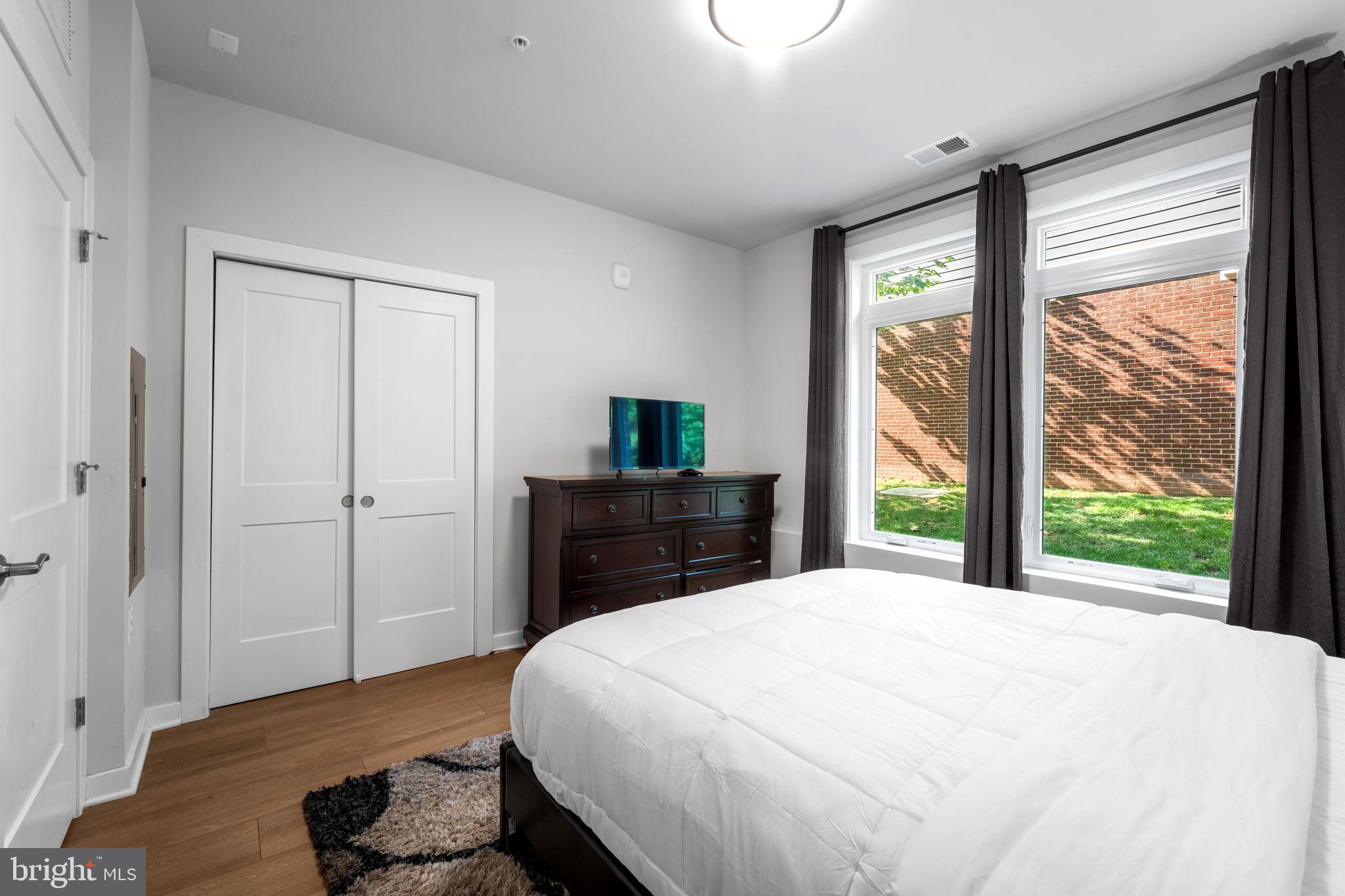 1669 Bandit Loop, Unit 101A Reston, VA 20190 - Photo 20 of 35 a bedroom with a large bed and a large window