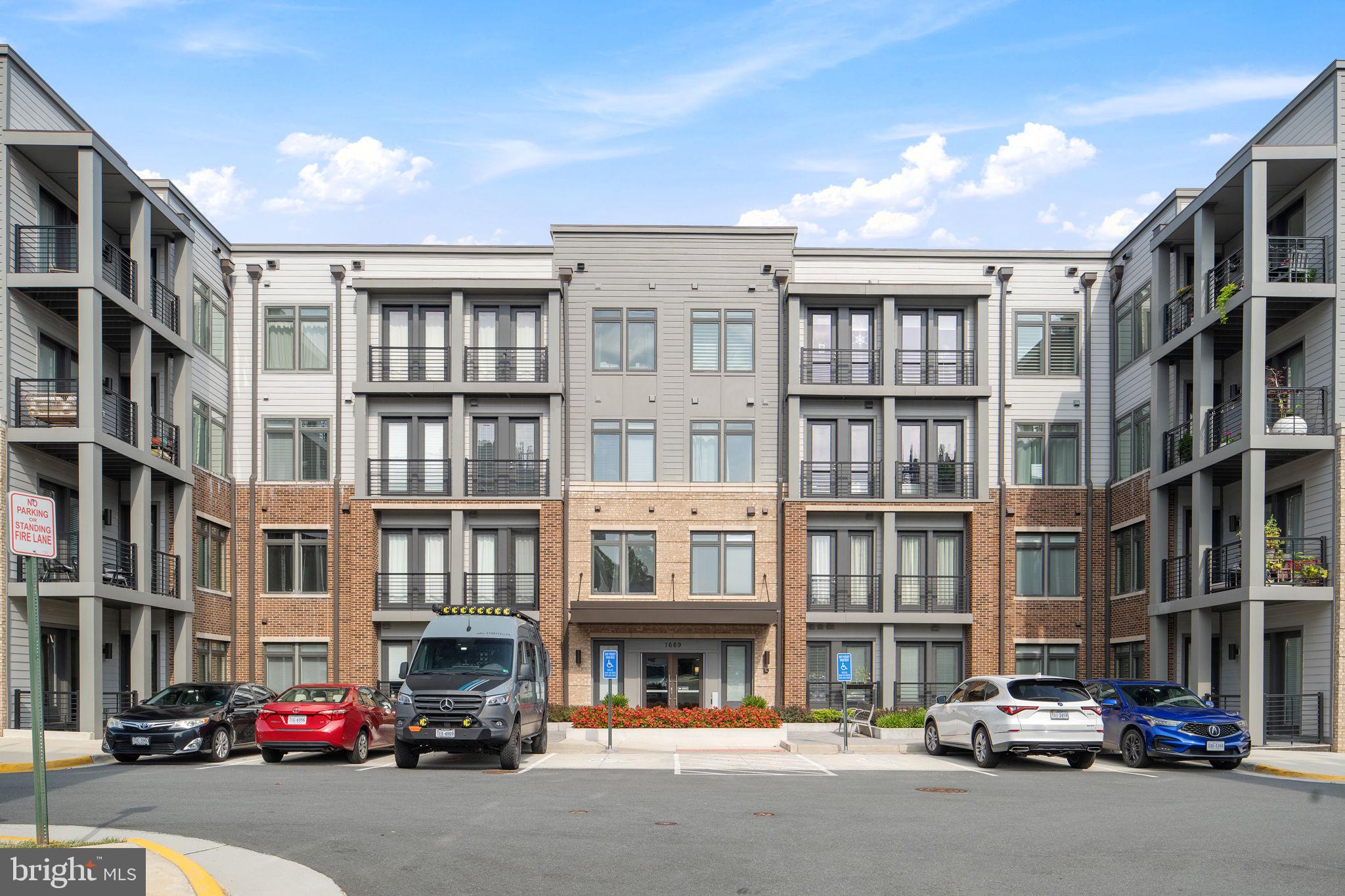 1669 Bandit Loop, Unit 101A Reston, VA 20190 - Photo 2 of 35 a city street lined with cars and buildings