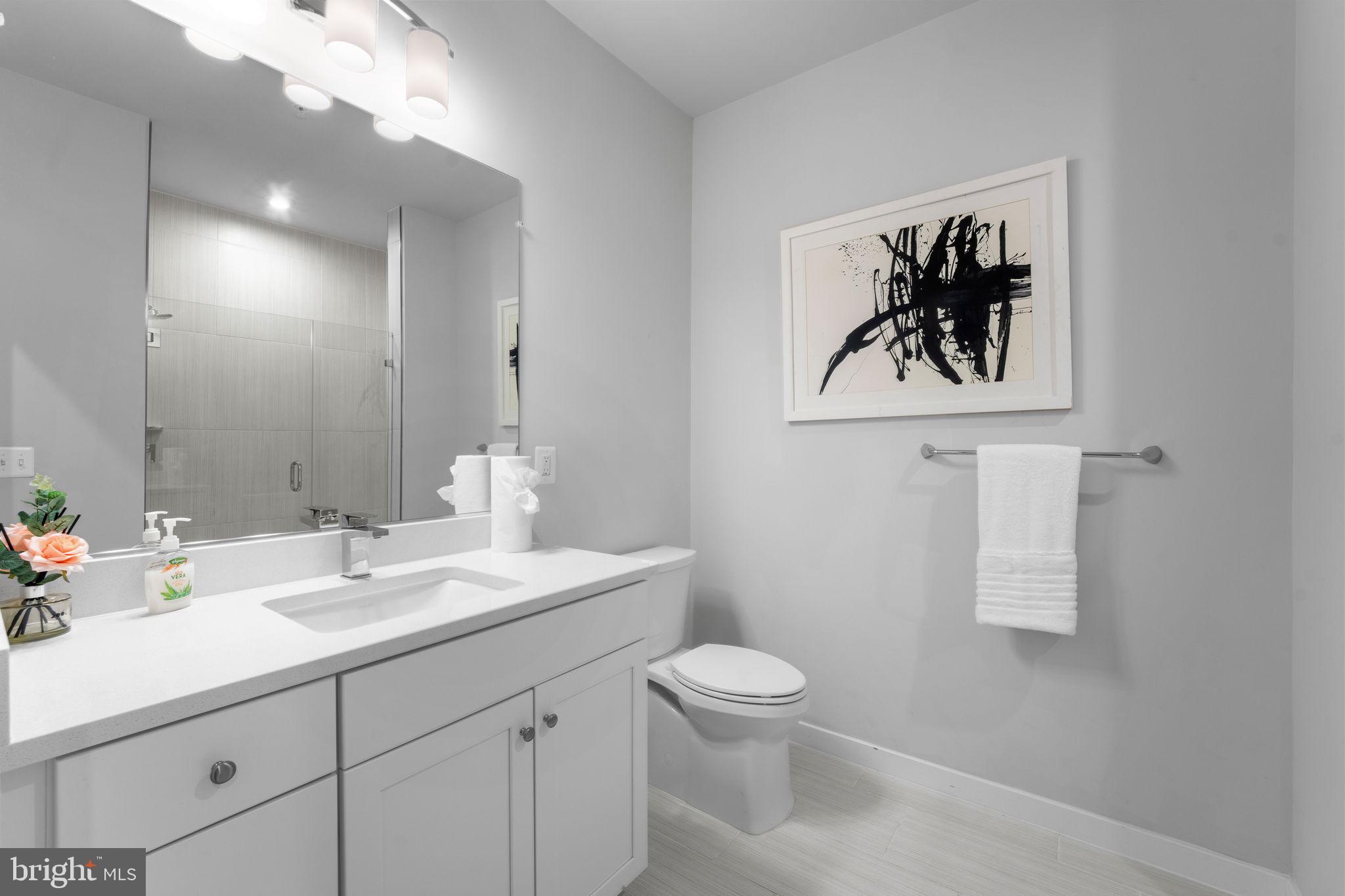 1669 Bandit Loop, Unit 101A Reston, VA 20190 - Photo 21 of 35 a bathroom with a toilet sink and mirror