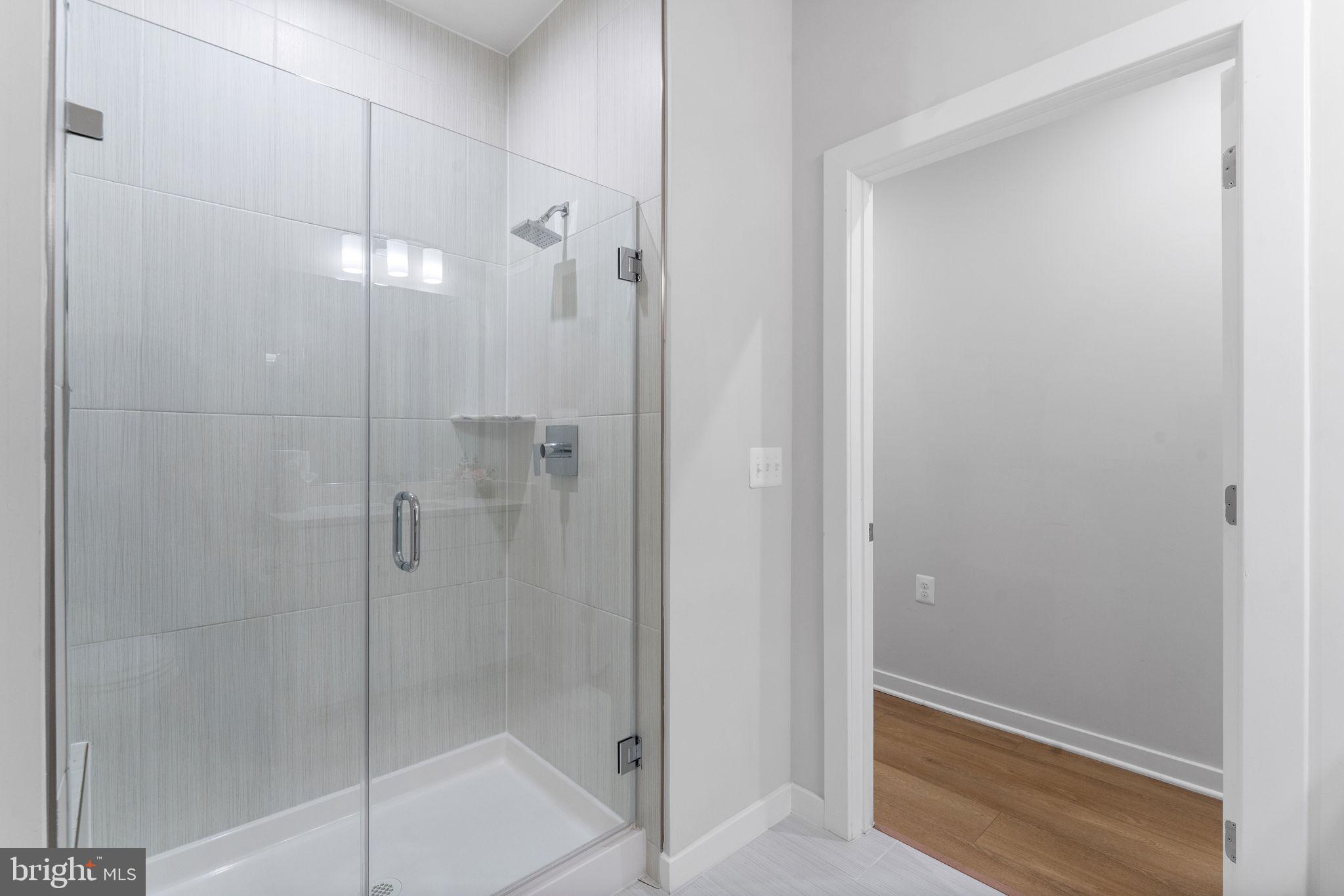 1669 Bandit Loop, Unit 101A Reston, VA 20190 - Photo 22 of 35 a bathroom with a glass shower door