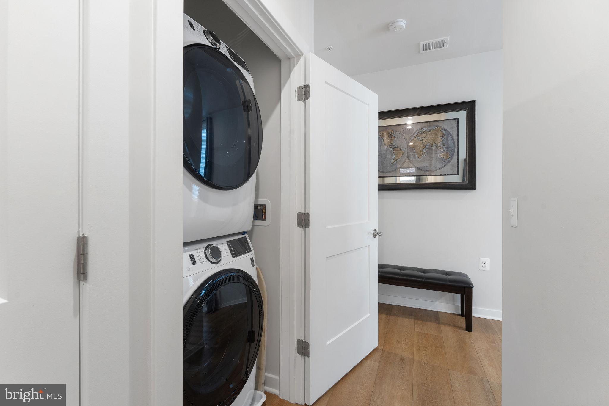 1669 Bandit Loop, Unit 101A Reston, VA 20190 - Photo 23 of 35 a utility room with dryer washer and a view of bathroom