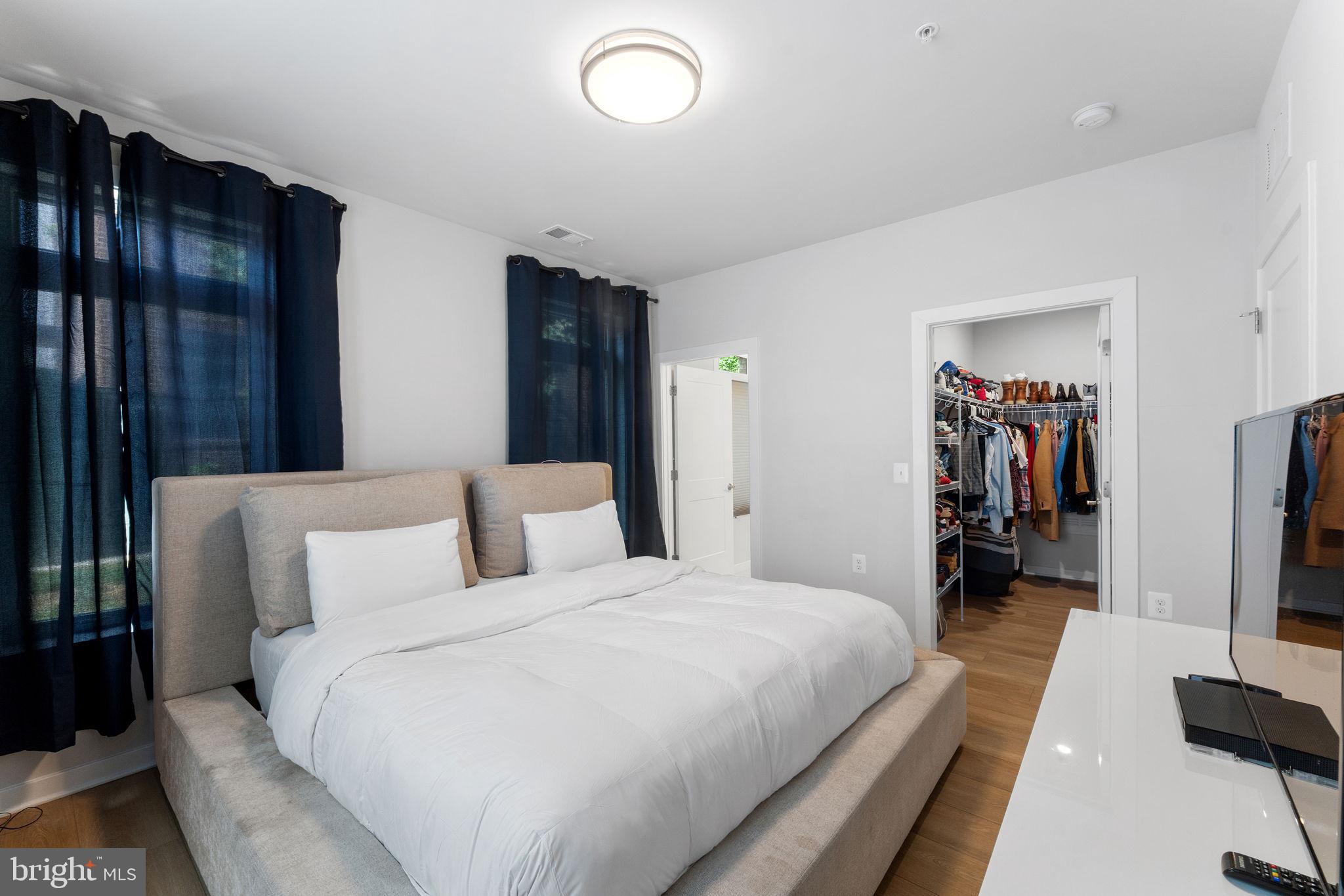 1669 Bandit Loop, Unit 101A Reston, VA 20190 - Photo 26 of 35 a bedroom with bed and walk in closet