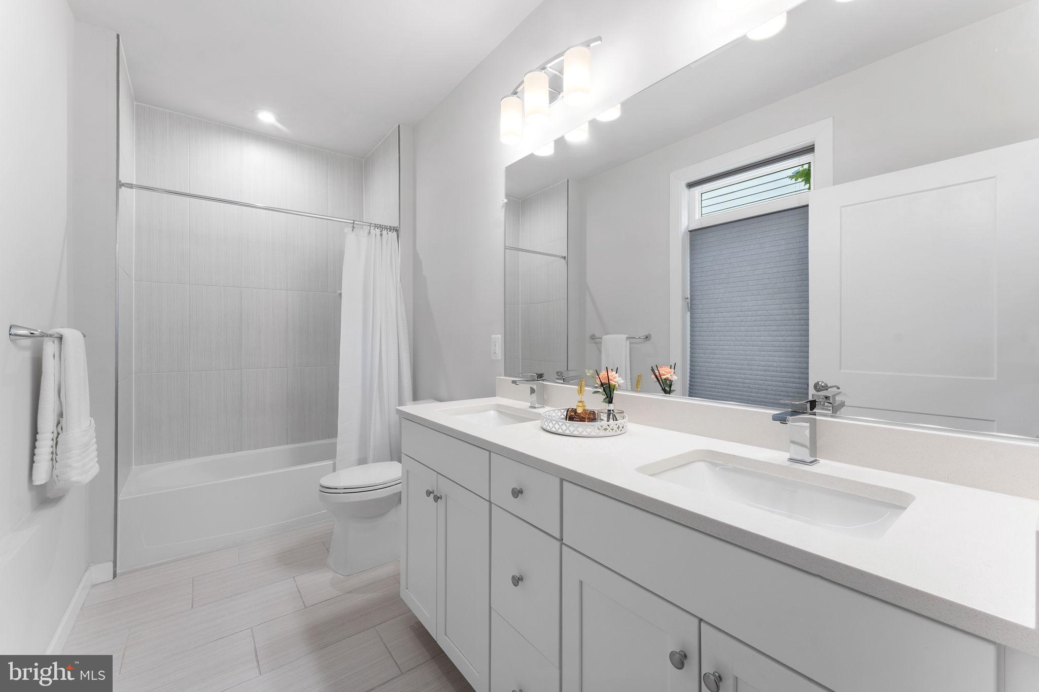 1669 Bandit Loop, Unit 101A Reston, VA 20190 - Photo 27 of 35 a bathroom with a sink a toilet and shower