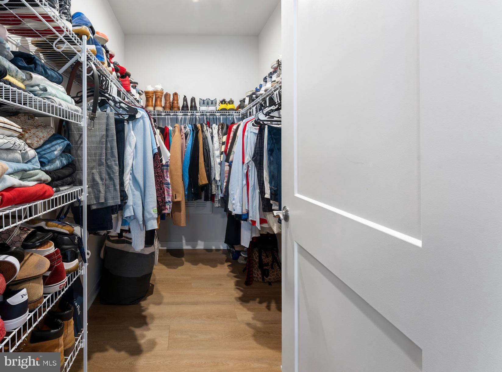 1669 Bandit Loop, Unit 101A Reston, VA 20190 - Photo 28 of 35 a view of walk in closet with clothes