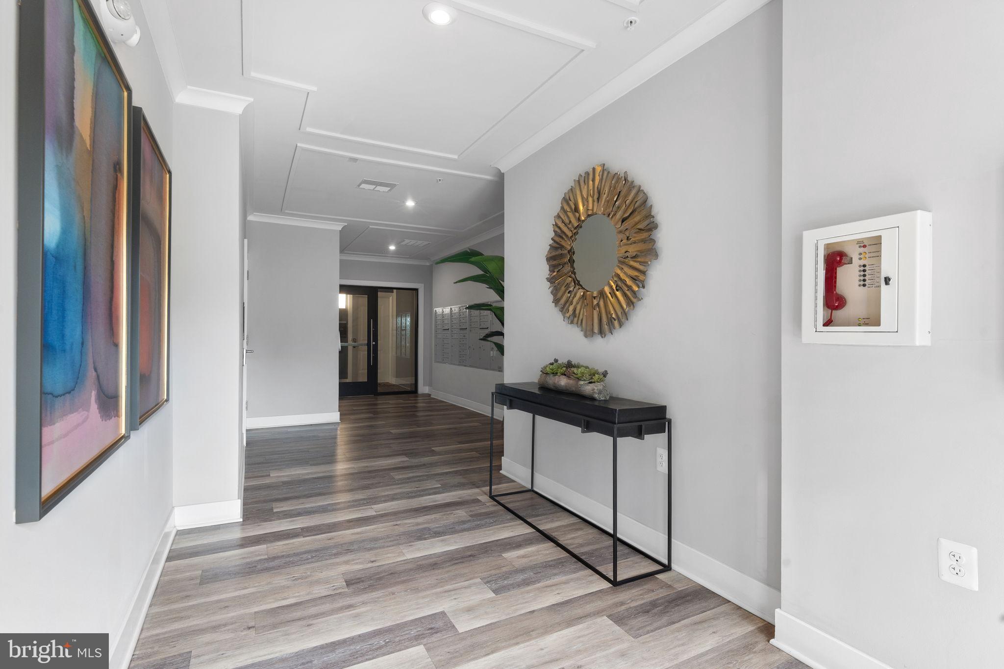1669 Bandit Loop, Unit 101A Reston, VA 20190 - Photo 30 of 35 a view of a hallway with wooden floor
