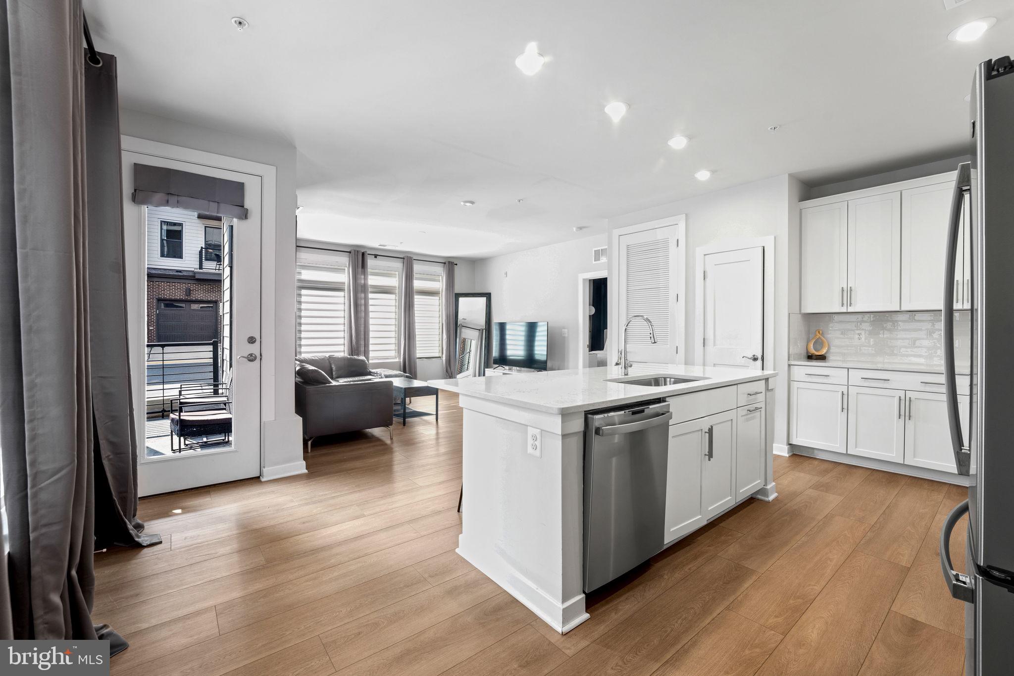 1669 Bandit Loop, Unit 101A Reston, VA 20190 - Photo 8 of 35 a kitchen with stove a sink and a refrigerator