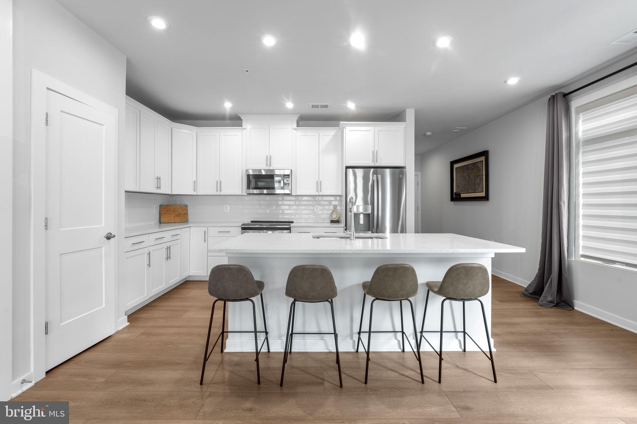 1669 Bandit Loop, Unit 101A Reston, VA 20190 - Photo 10 of 35 a kitchen with granite countertop white cabinets and refrigerator