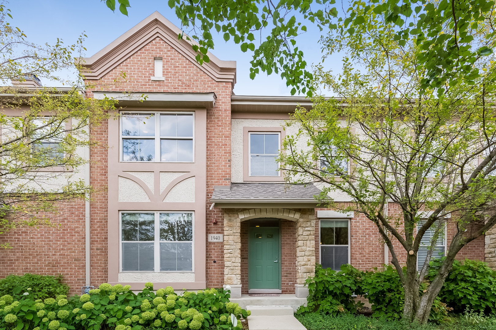 1940 Brentwood Road Northbrook, IL 60062 - Photo 1 of 22 a front view of a house with a yard