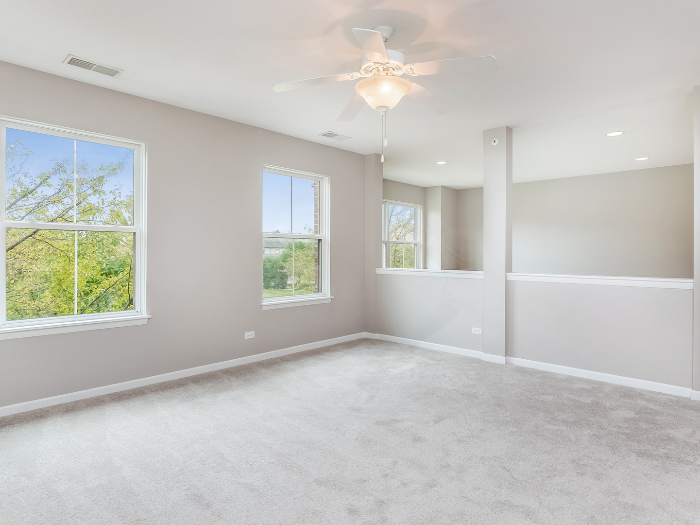 1940 Brentwood Road Northbrook, IL 60062 - Photo 12 of 22 an empty room with windows and ceiling fan