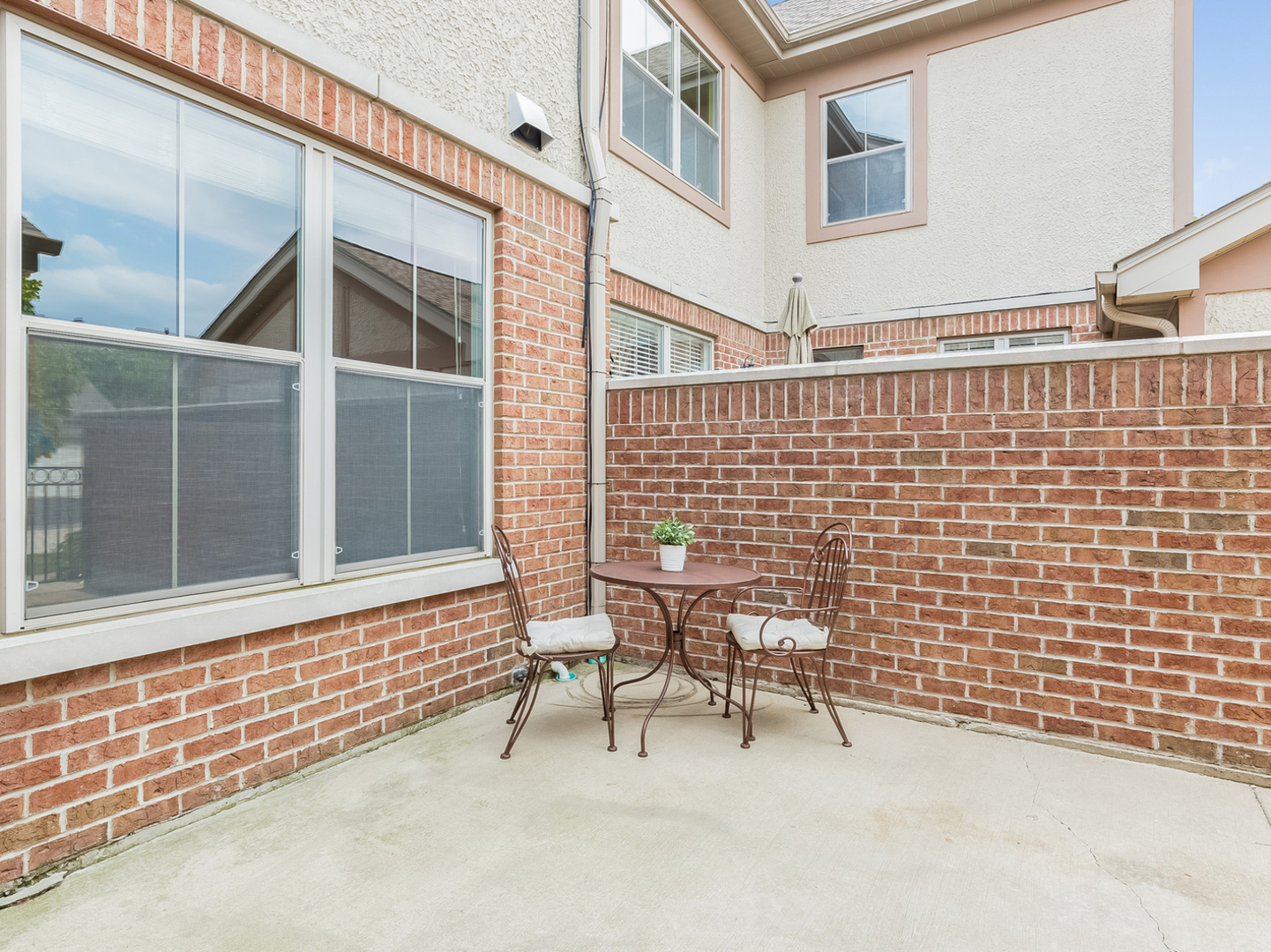 1940 Brentwood Road Northbrook, IL 60062 - Photo 16 of 22 a view of a house with a bench and chair