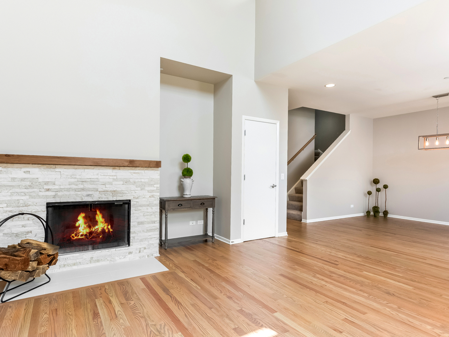 1940 Brentwood Road Northbrook, IL 60062 - Photo 3 of 22 a view of an empty room with wooden floor and a fire place