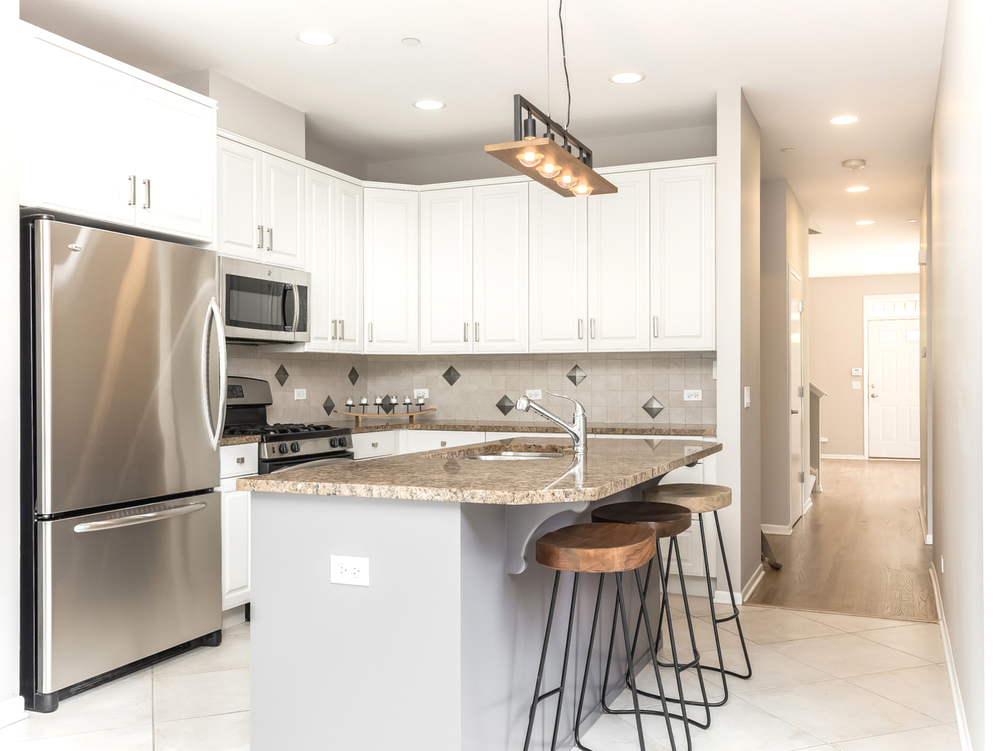 1940 Brentwood Road Northbrook, IL 60062 - Photo 5 of 22 a kitchen with a refrigerator a sink and a stove