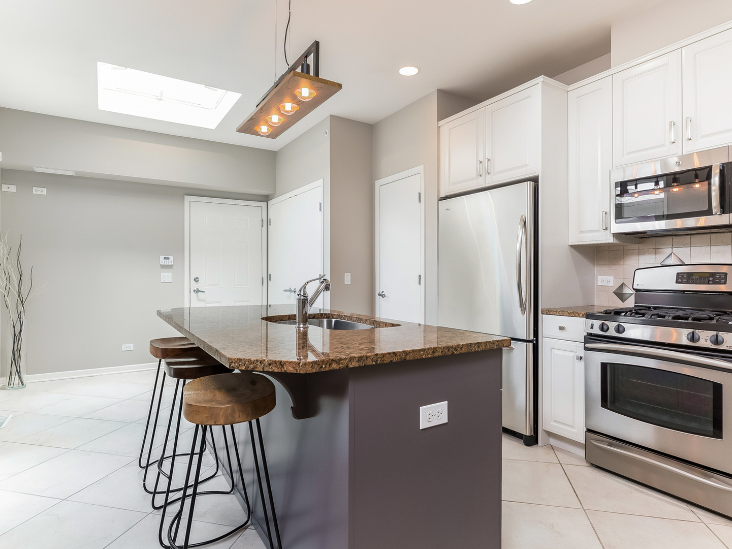 1940 Brentwood Road Northbrook, IL 60062 - Photo 6 of 22 a kitchen with stainless steel appliances granite countertop a sink a stove a refrigerator and island