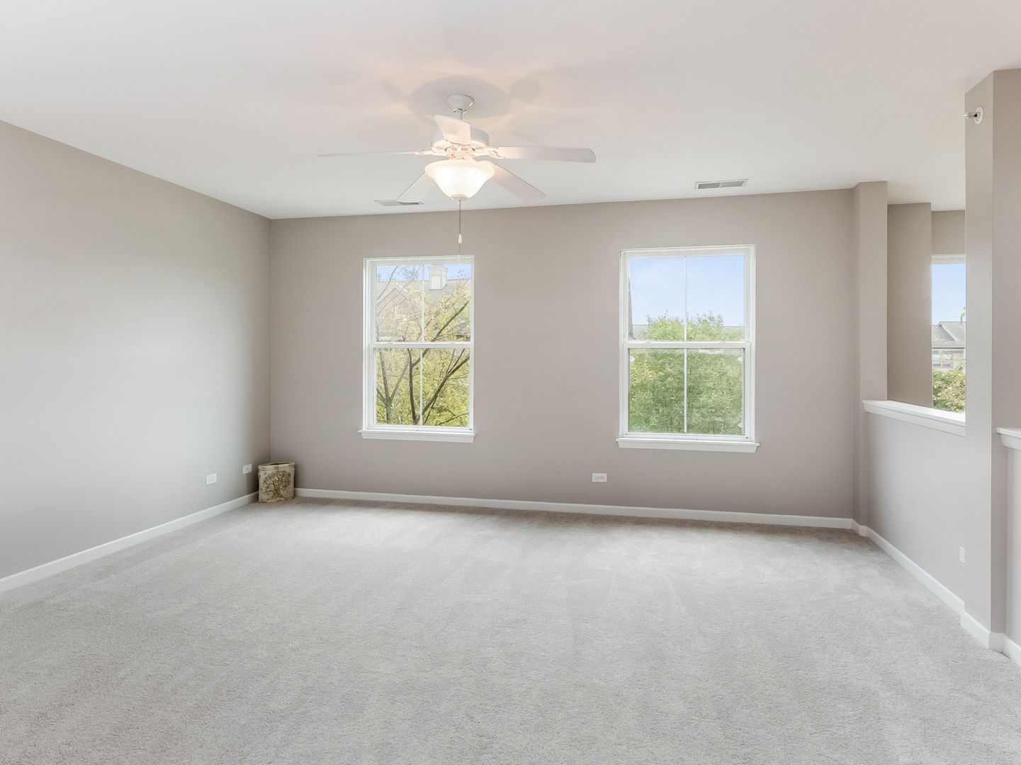 1940 Brentwood Road Northbrook, IL 60062 - Photo 10 of 22 an empty room with windows and chandelier fan