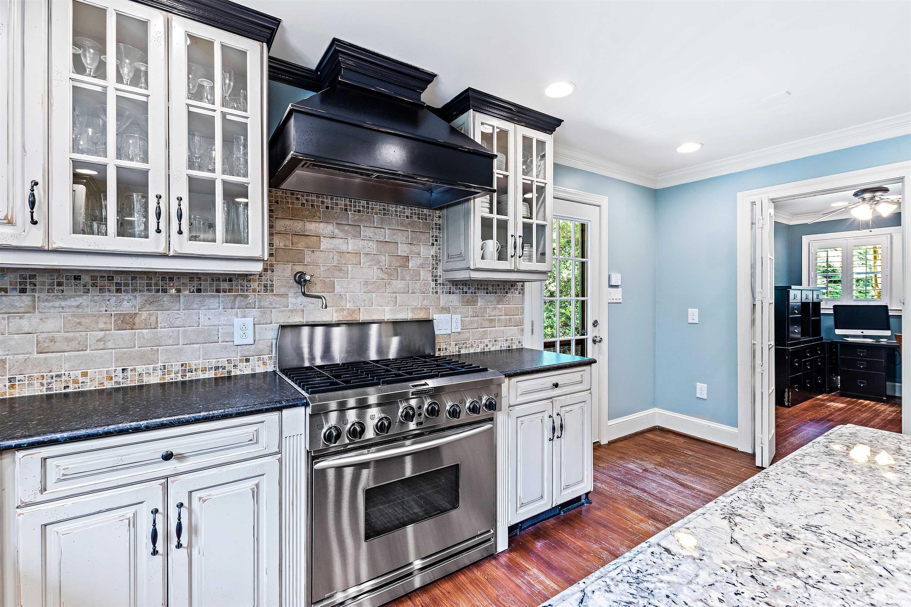 1419 Lutz Avenue Raleigh, NC 27607 - Photo 9 of 56 a kitchen with stainless steel appliances granite countertop a stove and a granite counter tops