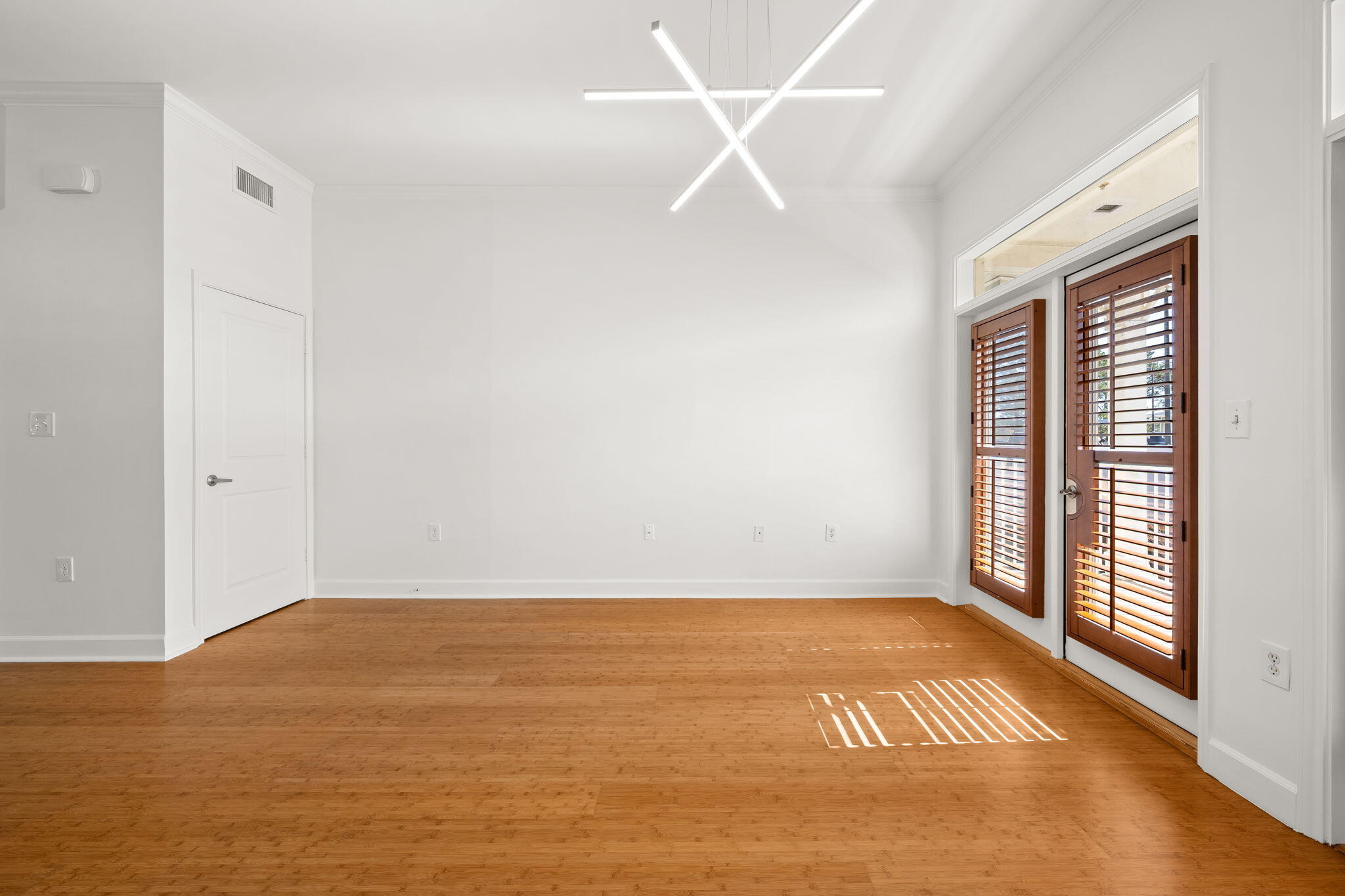 8700 Front Beach Road, Unit 6301 Panama City Beach, FL 32407 - Photo 18 of 82 an empty room with wooden floor and windows