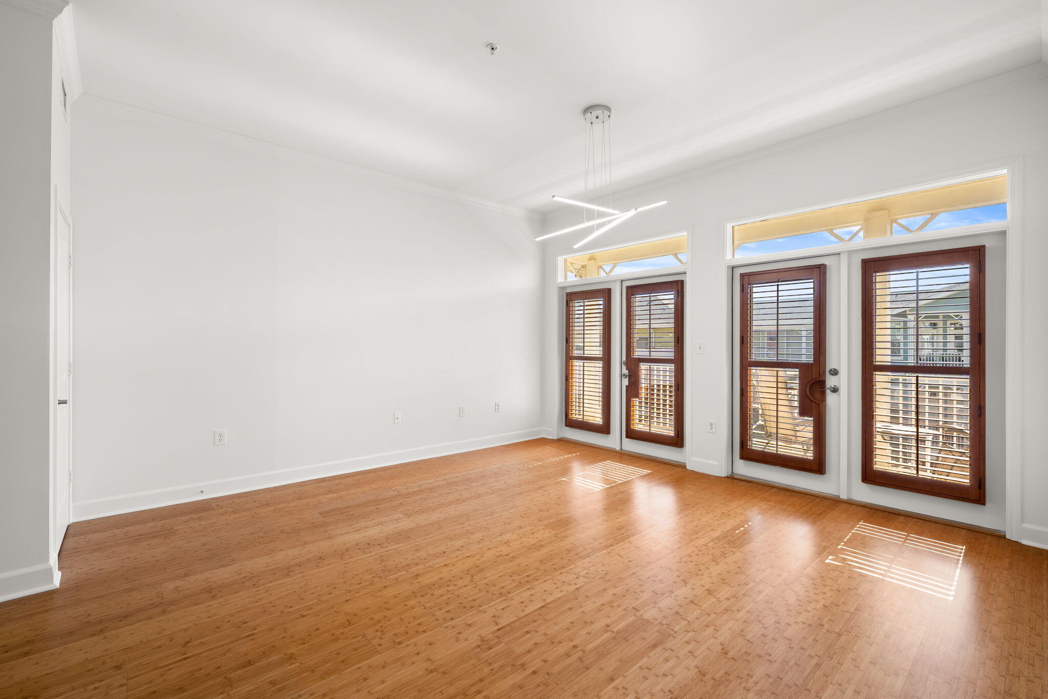 8700 Front Beach Road, Unit 6301 Panama City Beach, FL 32407 - Photo 19 of 82 an empty room with wooden floor and windows