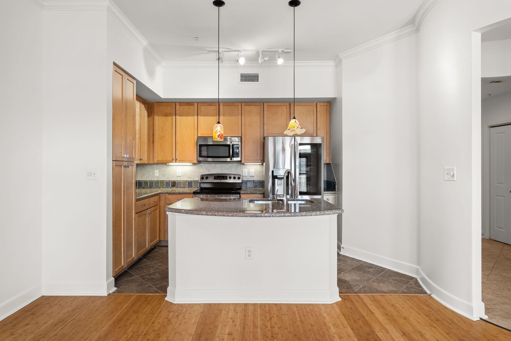 8700 Front Beach Road, Unit 6301 Panama City Beach, FL 32407 - Photo 21 of 82 a kitchen with stainless steel appliances a refrigerator a stove a sink and a wooden floors