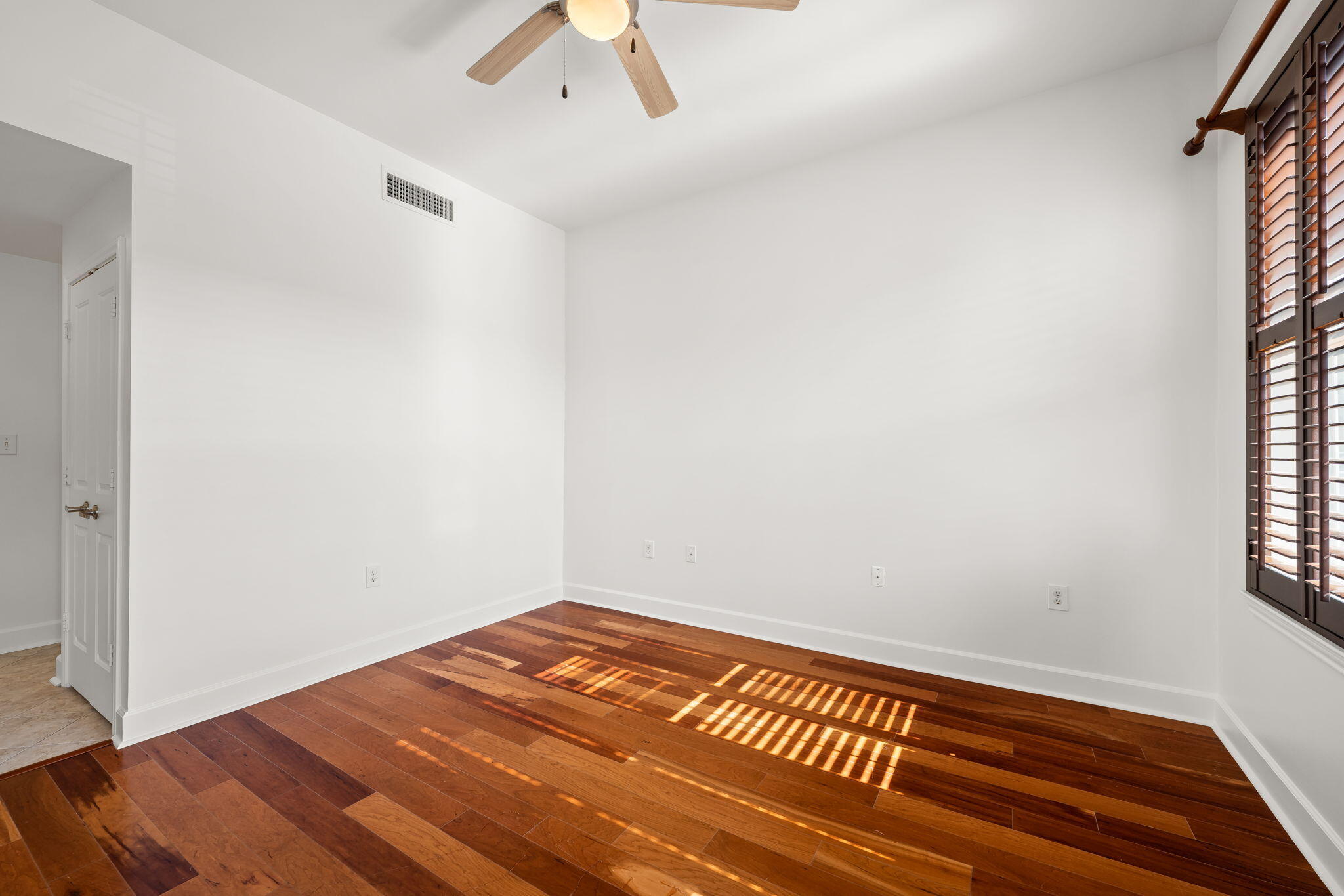 8700 Front Beach Road, Unit 6301 Panama City Beach, FL 32407 - Photo 29 of 82 a view of a room with wooden floor and a ceiling fan