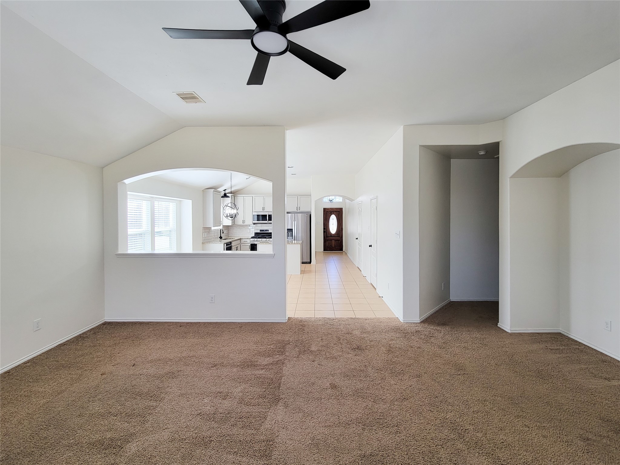 13935 Kenswick Key Lane Houston, TX 77047 - Photo 16 of 33 a view of a room with a ceiling fan and a window