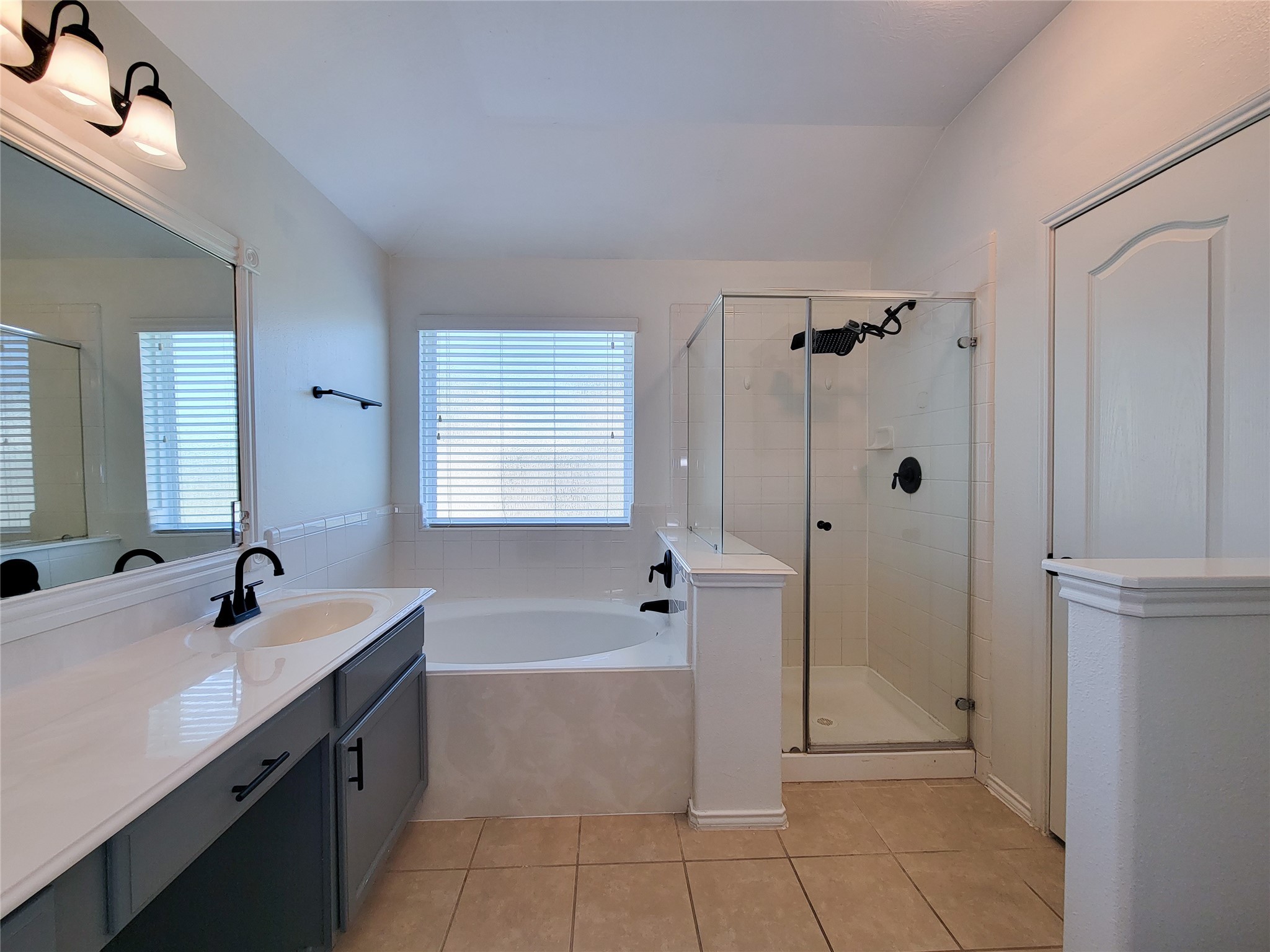 13935 Kenswick Key Lane Houston, TX 77047 - Photo 22 of 33 a bathroom with a tub sink shower and mirror
