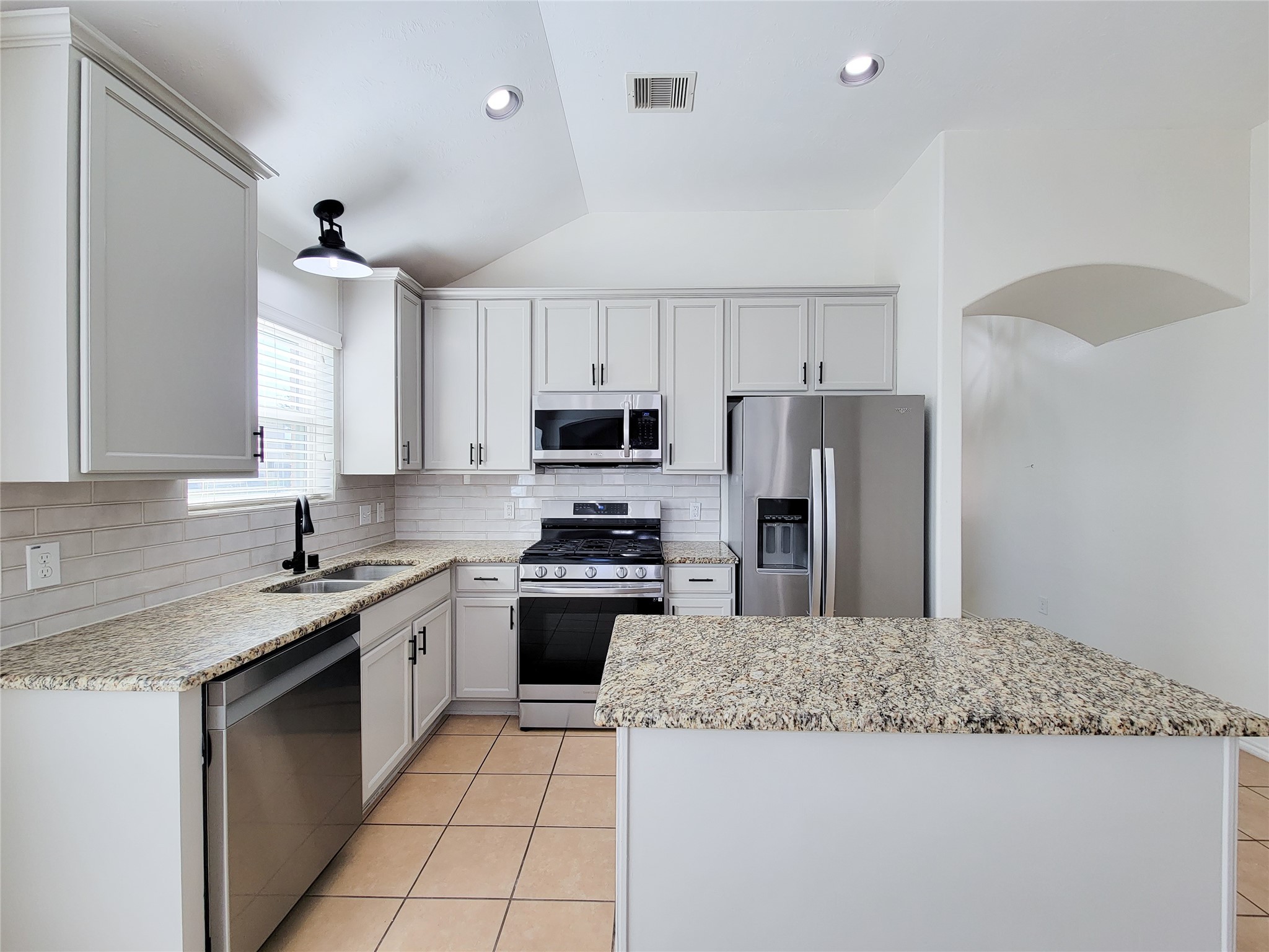 13935 Kenswick Key Lane Houston, TX 77047 - Photo 5 of 33 a kitchen with stainless steel appliances granite countertop a sink stove microwave and refrigerator