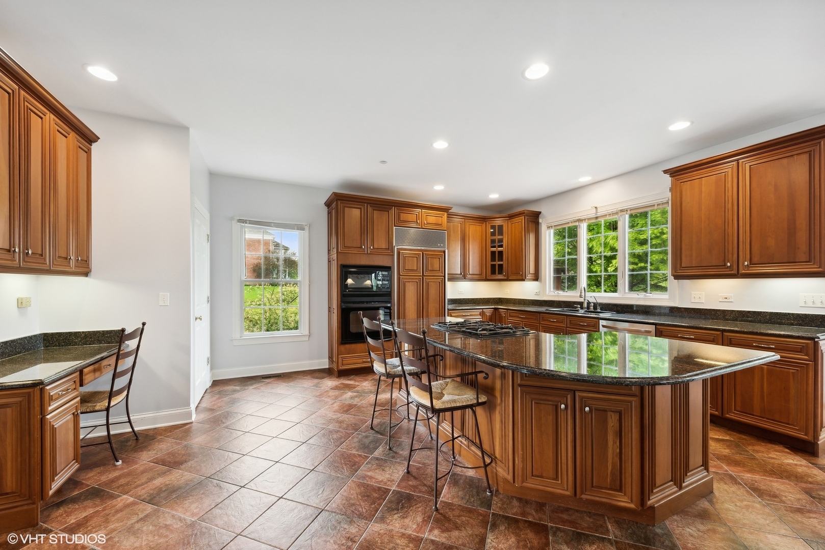 23914 Hillfarm Road Lake Barrington, IL 60010 - Photo 14 of 43 a kitchen with granite countertop sink cabinets dining table and chairs