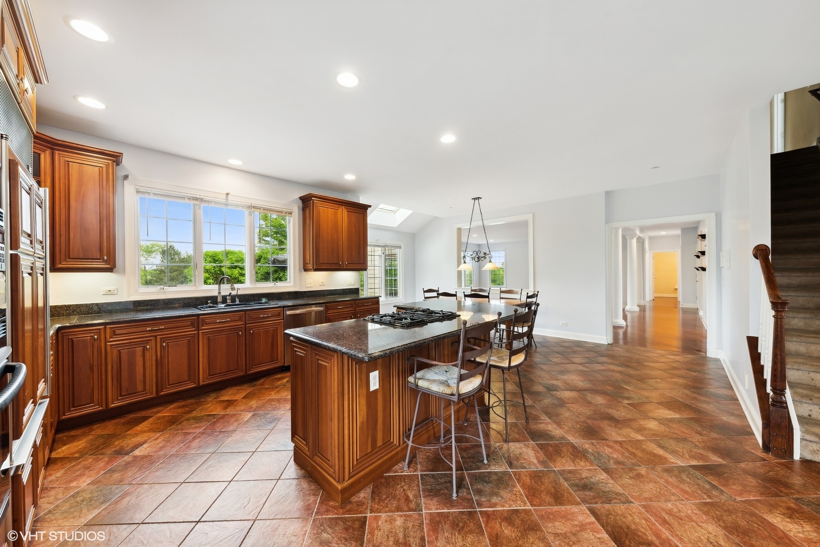 23914 Hillfarm Road Lake Barrington, IL 60010 - Photo 15 of 43 a kitchen with stainless steel appliances kitchen island granite countertop a table chairs and a refrigerator