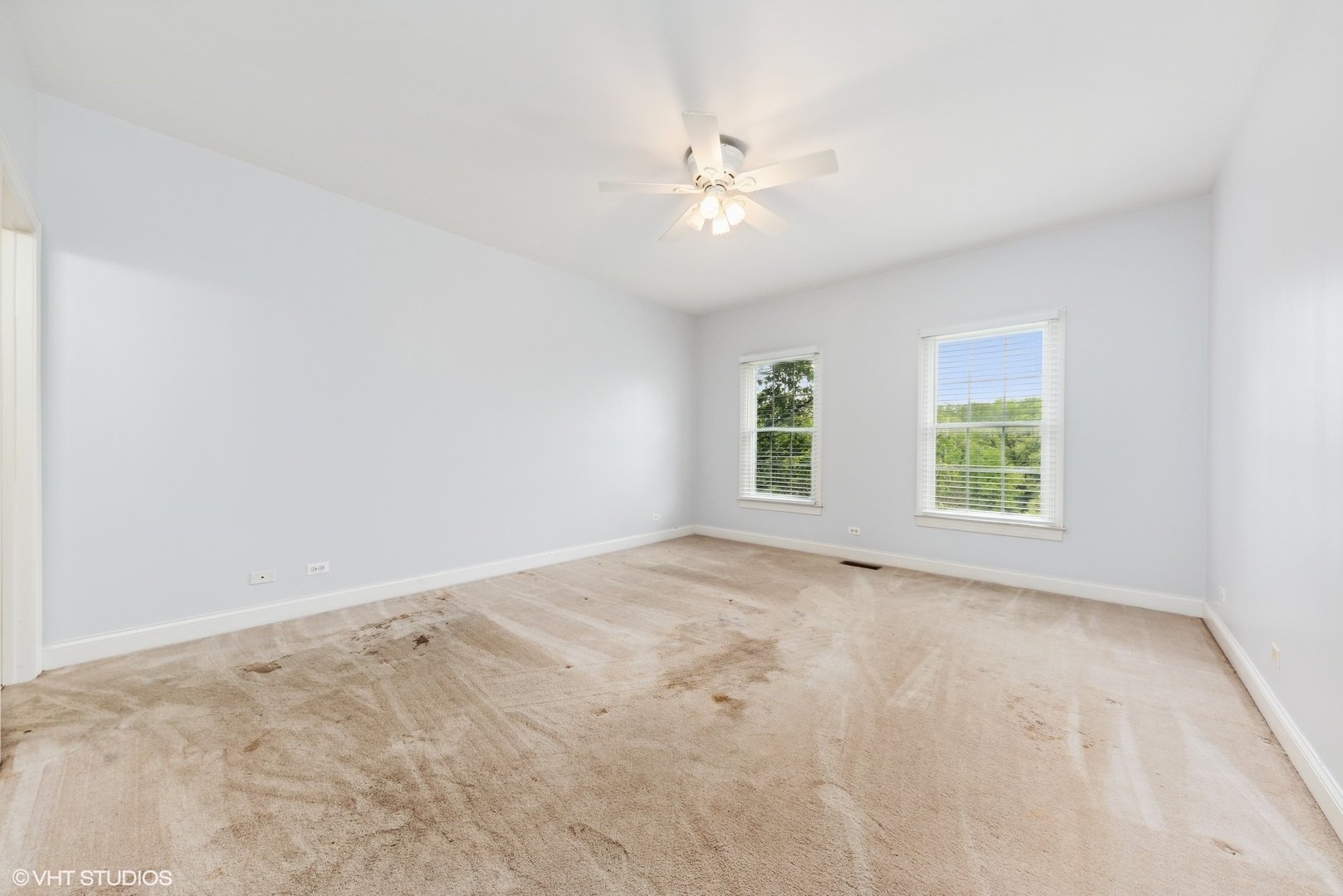 23914 Hillfarm Road Lake Barrington, IL 60010 - Photo 25 of 43 an empty room with windows and chandelier fan