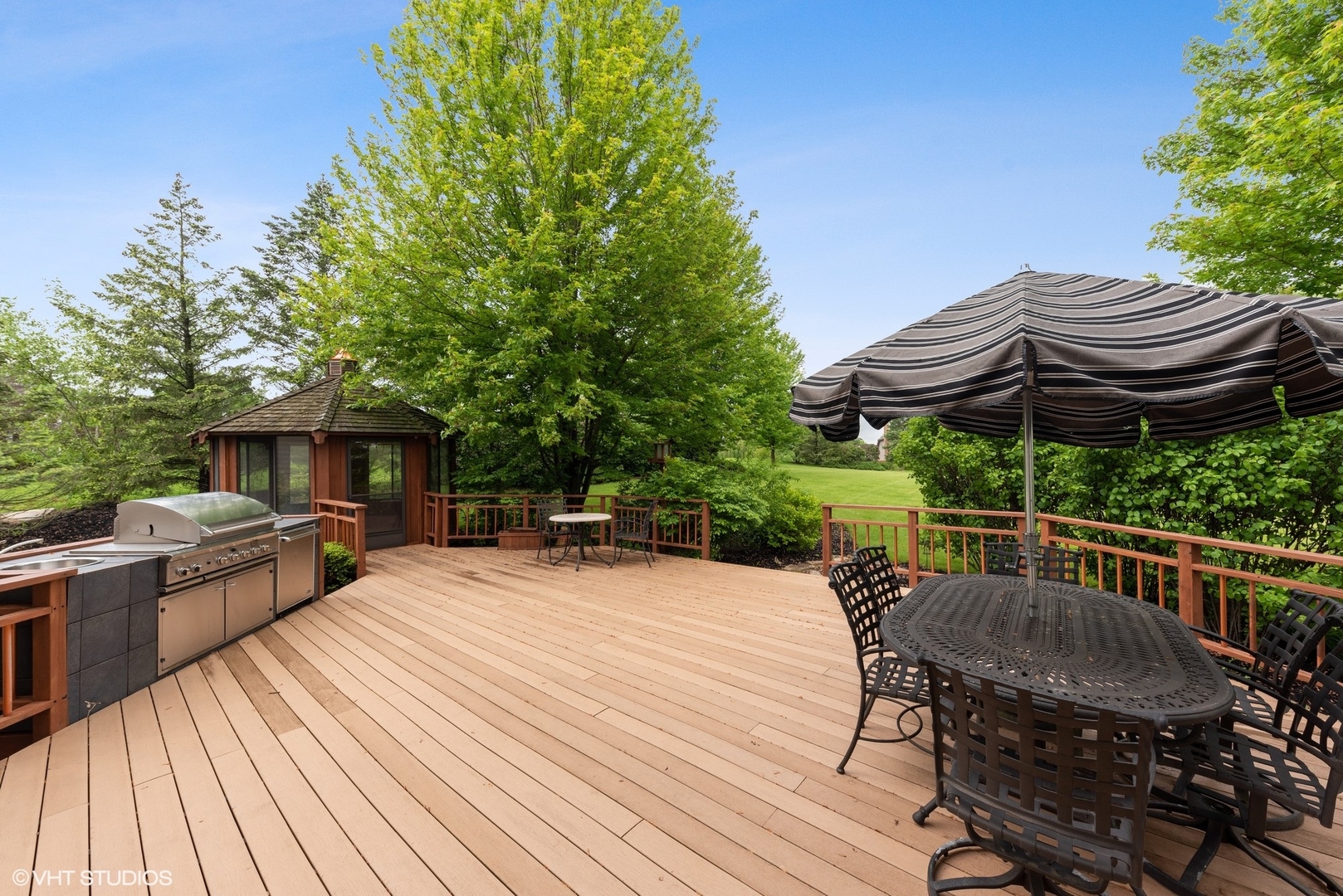 23914 Hillfarm Road Lake Barrington, IL 60010 - Photo 3 of 43 a view of a patio with table and chairs under an umbrella with wooden floor