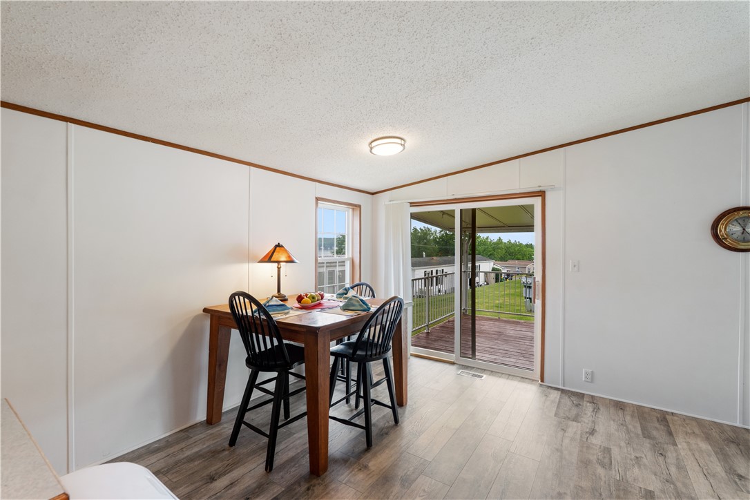 4795 East Lake Road, Unit 32 Livonia, NY 14487 - Photo 9 of 47 Eat-in area next to the slider leading the the cov