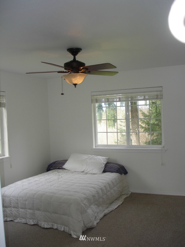 15112 Littlerock Road Southwest Rochester, WA 98579 - Photo 14 of 15 a bedroom with a bed and a window