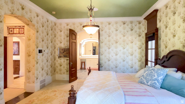 426 West Center Street Parowan, UT 84761 - Photo 26 of 107 Bedroom featuring patterned wallpaper, a green ceiling, crown molding, and an arched entryway with stained glass