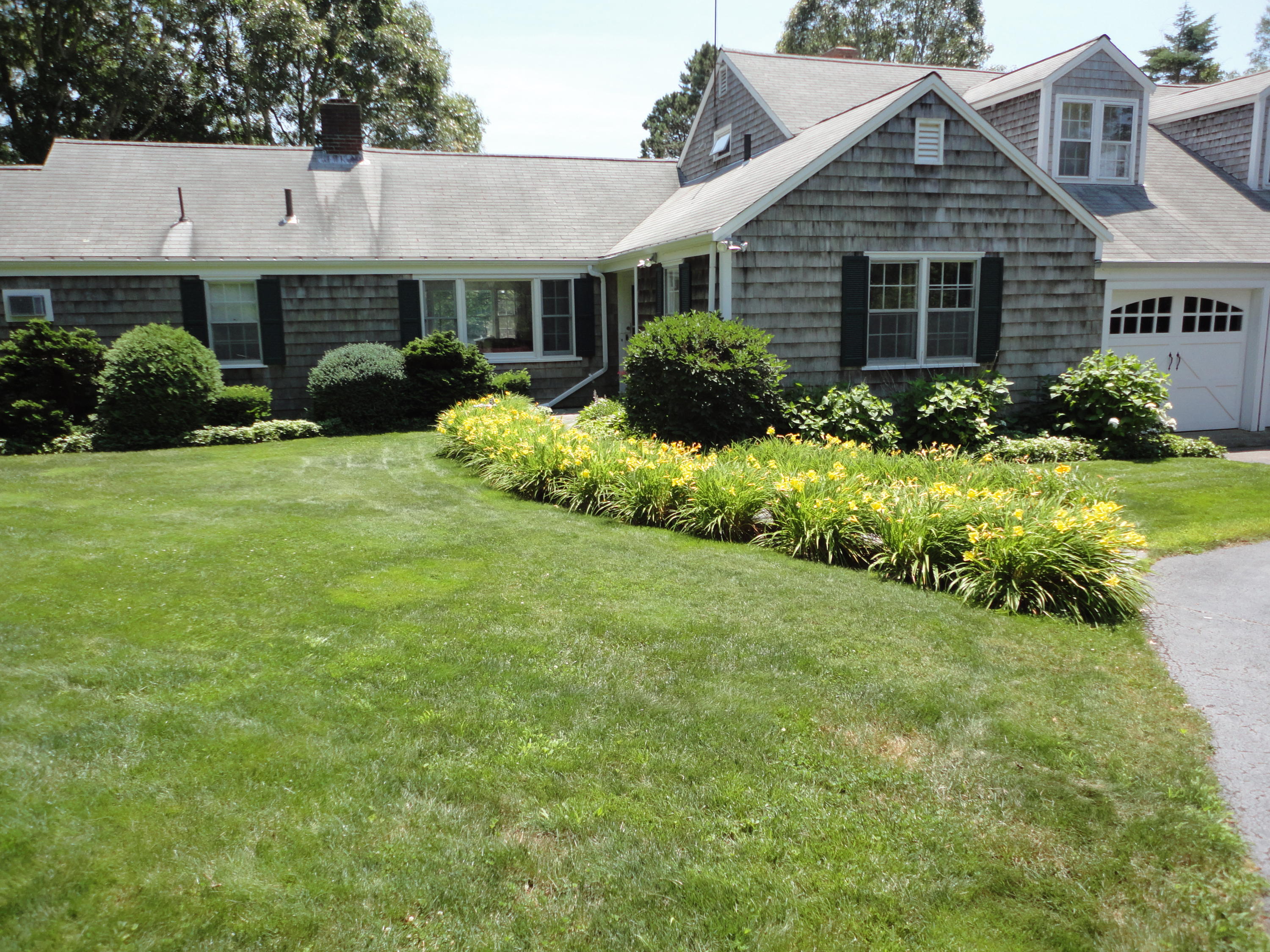 247 Crystal Lake Road Osterville, MA 02655 - Photo 1 of 34 a front view of a house with a yard and garage
