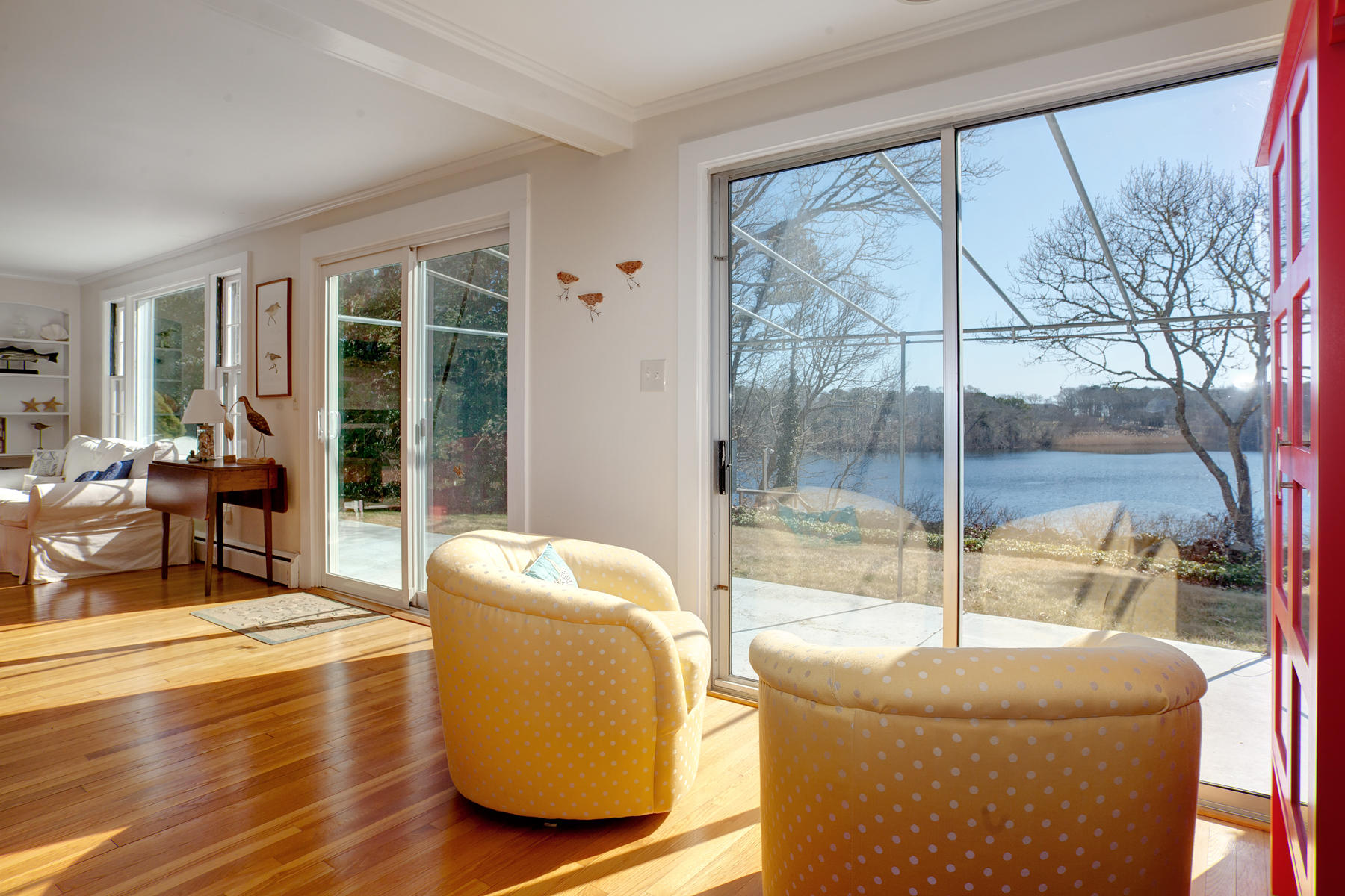 247 Crystal Lake Road Osterville, MA 02655 - Photo 18 of 34 a living room with couch and a floor to ceiling window
