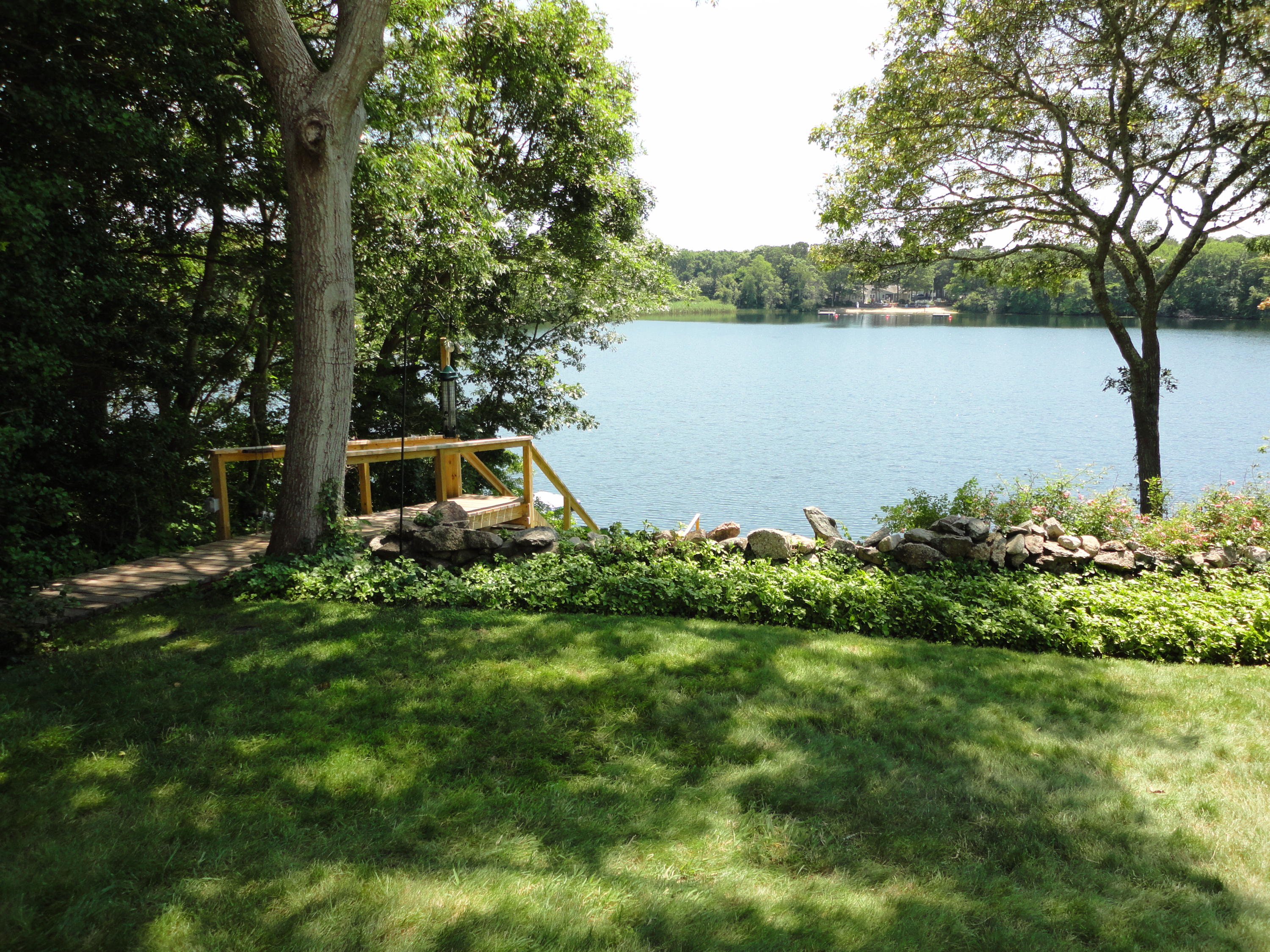 247 Crystal Lake Road Osterville, MA 02655 - Photo 4 of 34 a front view of a house with a yard and lake view