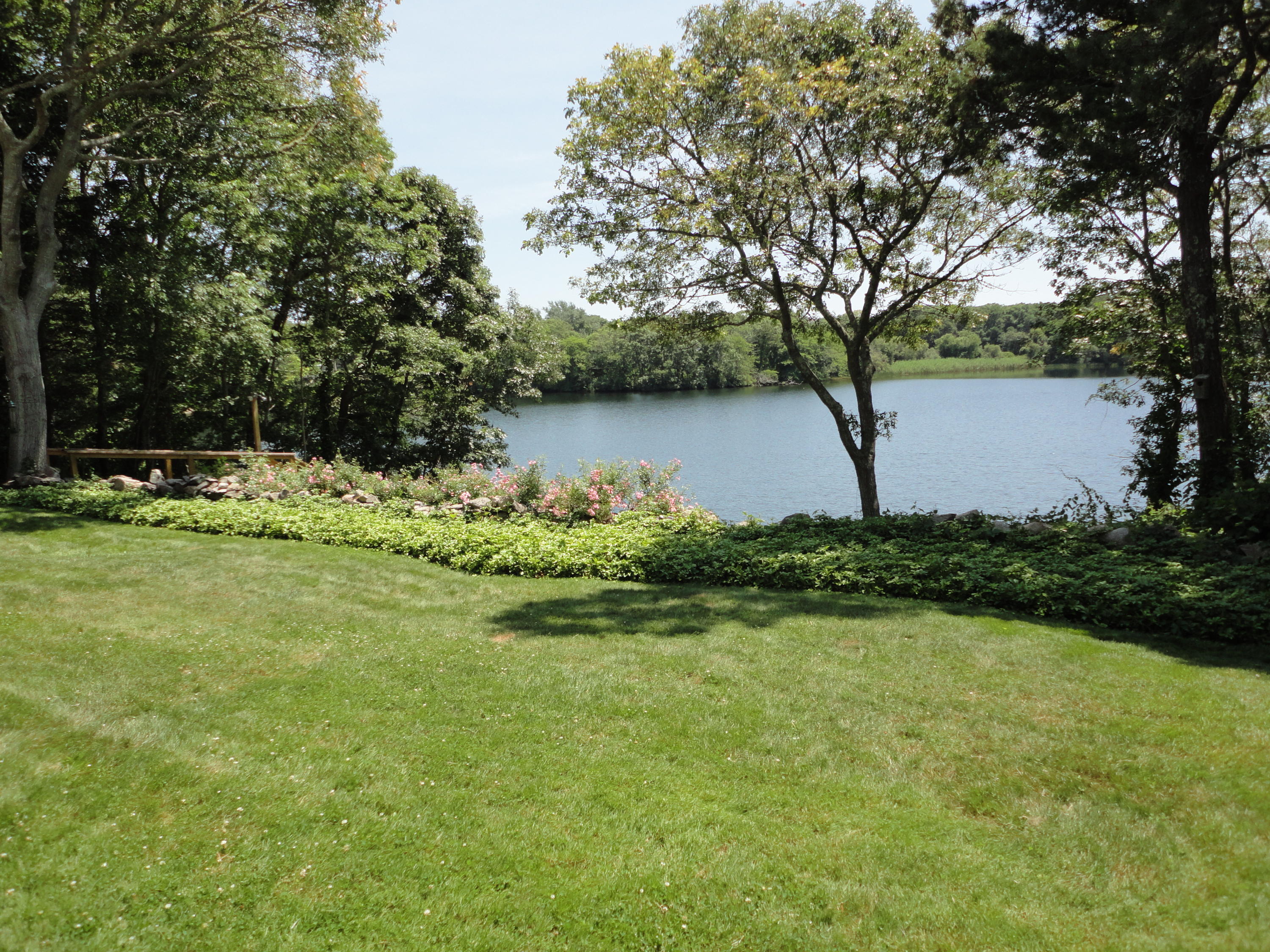 247 Crystal Lake Road Osterville, MA 02655 - Photo 5 of 34 a view of a lake from a yard