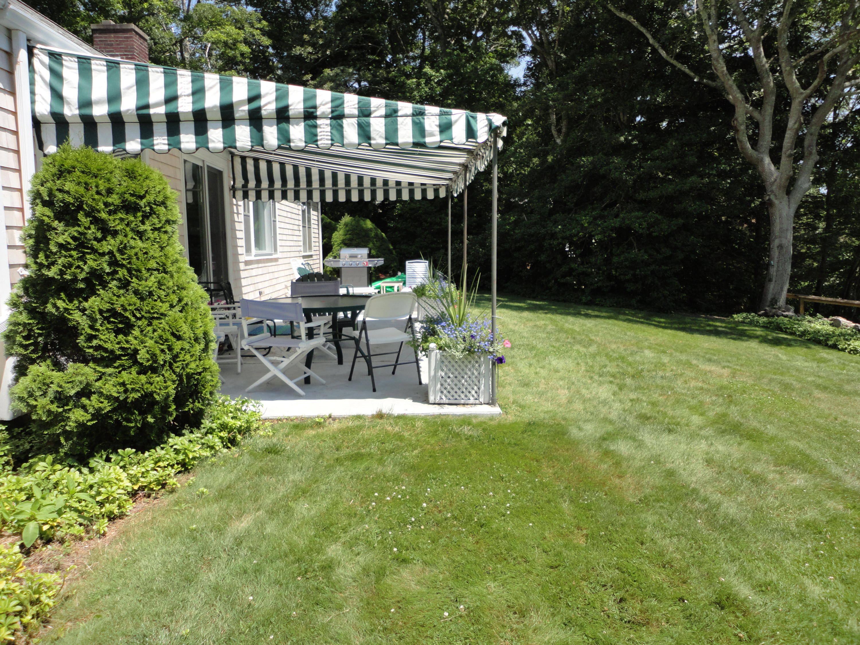 247 Crystal Lake Road Osterville, MA 02655 - Photo 9 of 34 a view of a chair and table in backyard of the house